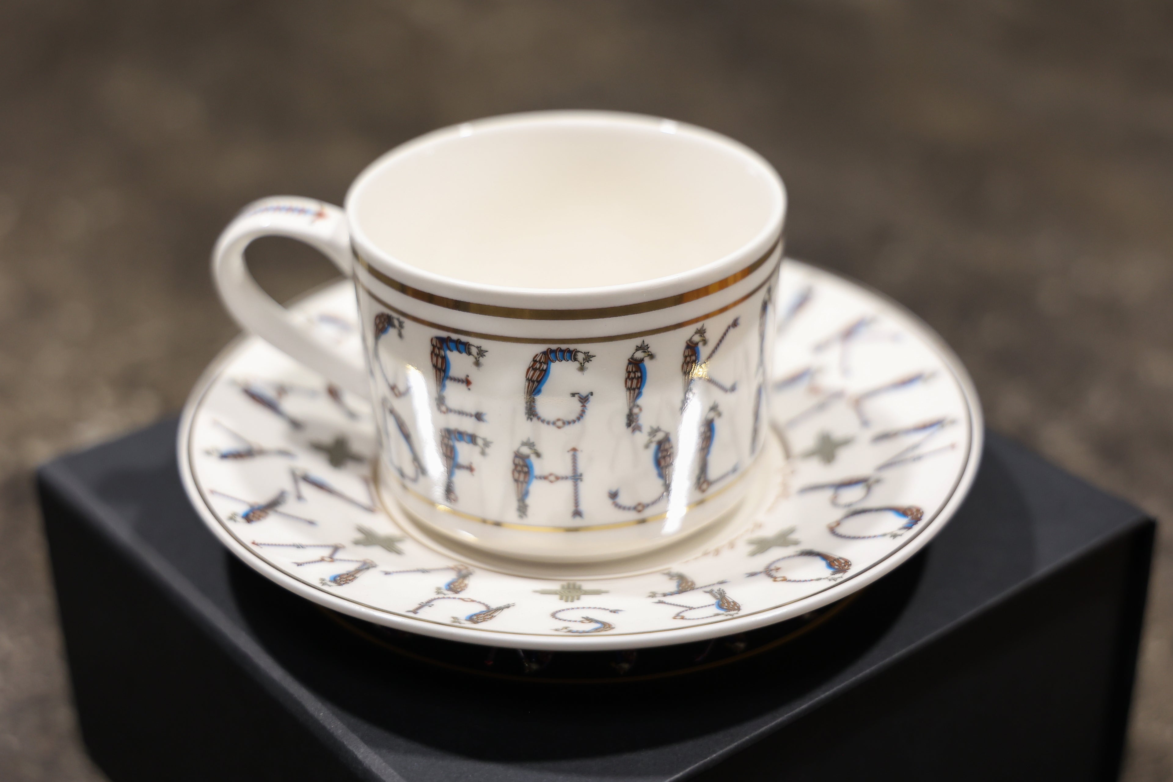 English Alphabet  — 24K Gold Porcelain Tea Cup & Saucer by KARCHIKYAN